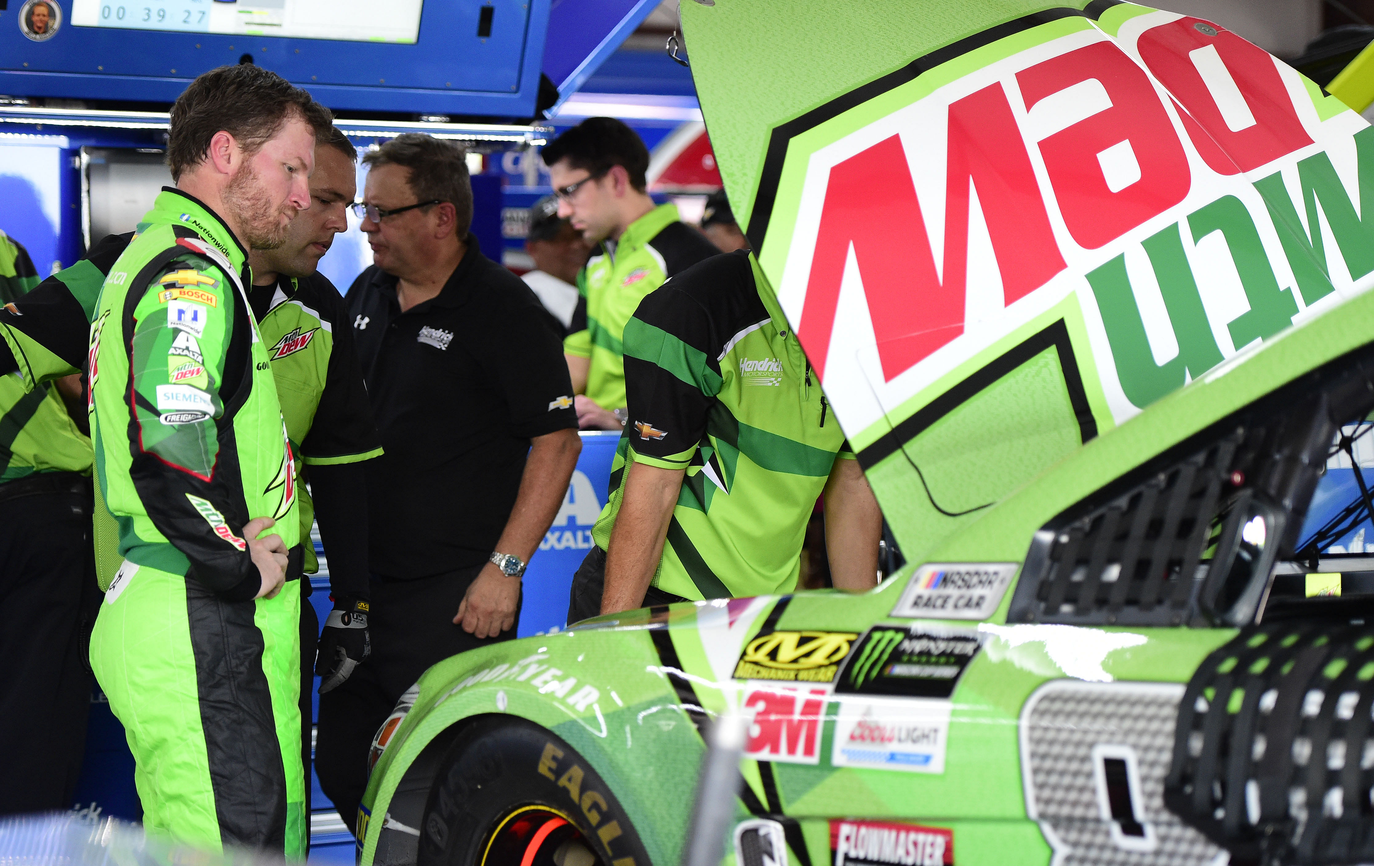 NASCAR Cup Series driver Dale Earnhardt Jr. (L) talks with crew members at Talladega. Source: Imagn